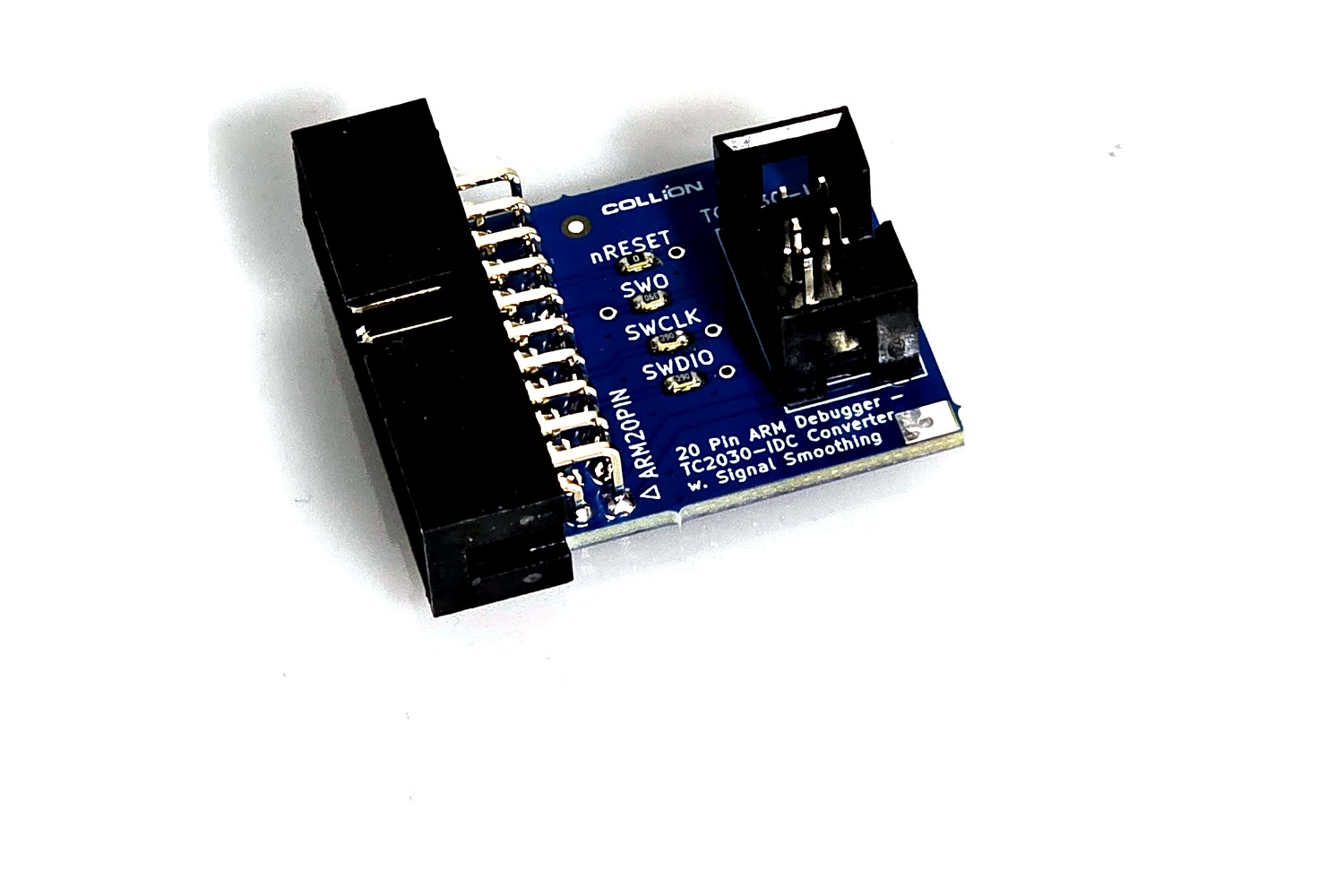 The blue adapter board at an angle: on the left the 20-pin ARM male header on 2.54 mm pitch, on the right the 6-pin IDC connector for the Tag-Connect cable. Between them the four series resistors, labelled nRESET, SWO, SWCLK and SWDIO.