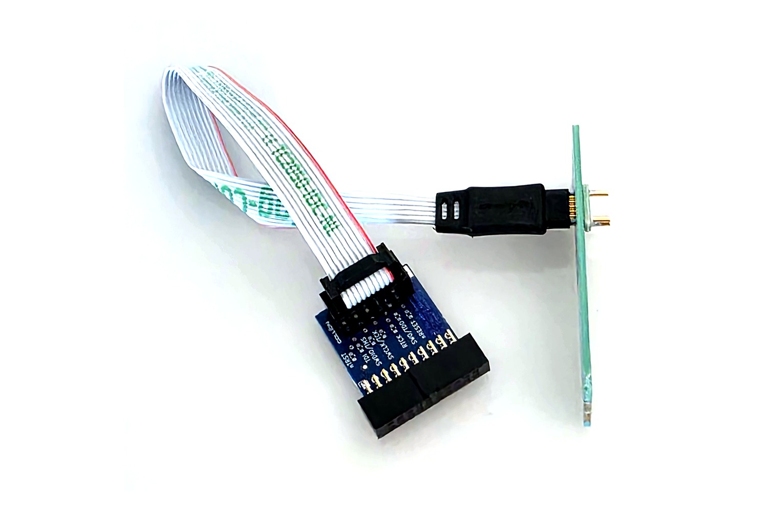 The set in use: the 10-pin connector head without legs sits on the footprint of a circuit board, the other end of the cable plugged onto the blue adapter board with its 20-pin ARM connector.